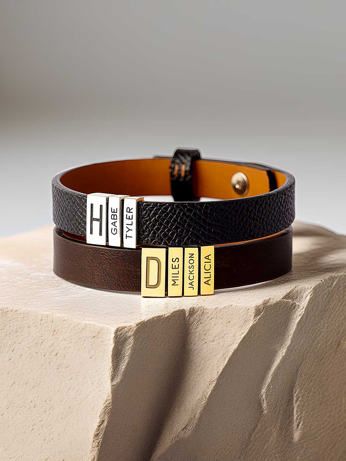 a couple of bracelets sitting on top of a rock