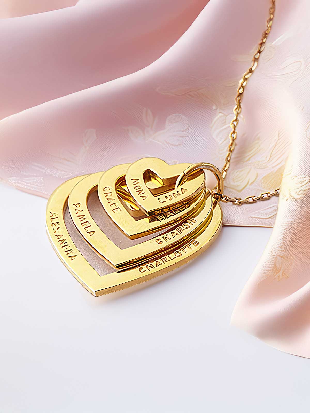 a gold plated necklace with three names on it