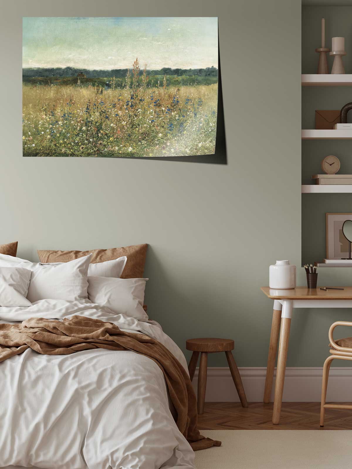 a serene bedroom scene with a large bed, a wooden table, and a painting of a field of flowers hanging on the wall.