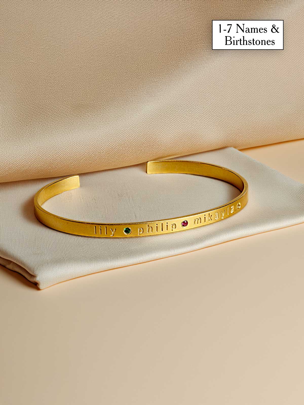 a gold bracelet with a name engraved on it