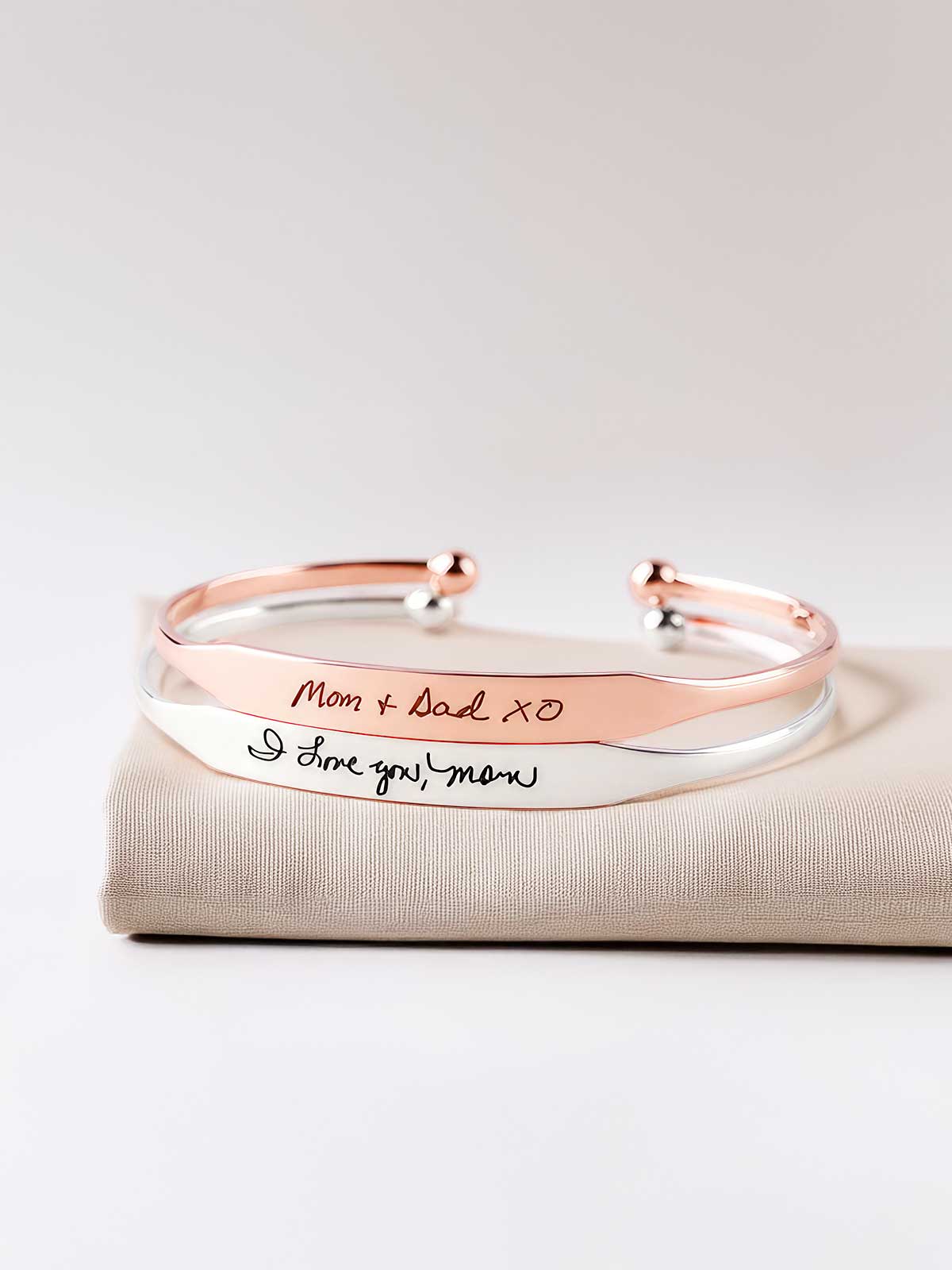 a pair of bracelets with handwriting on them