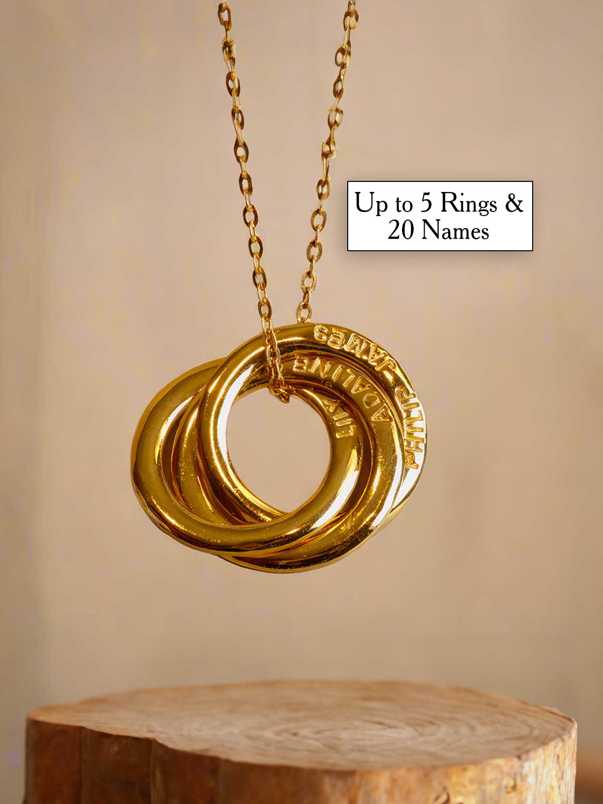 a gold necklace with three rings hanging from it