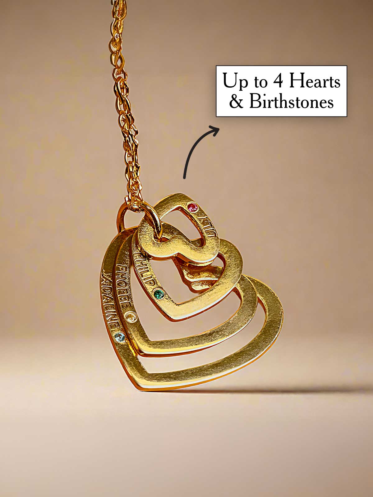 a gold necklace with a heart and two names on it