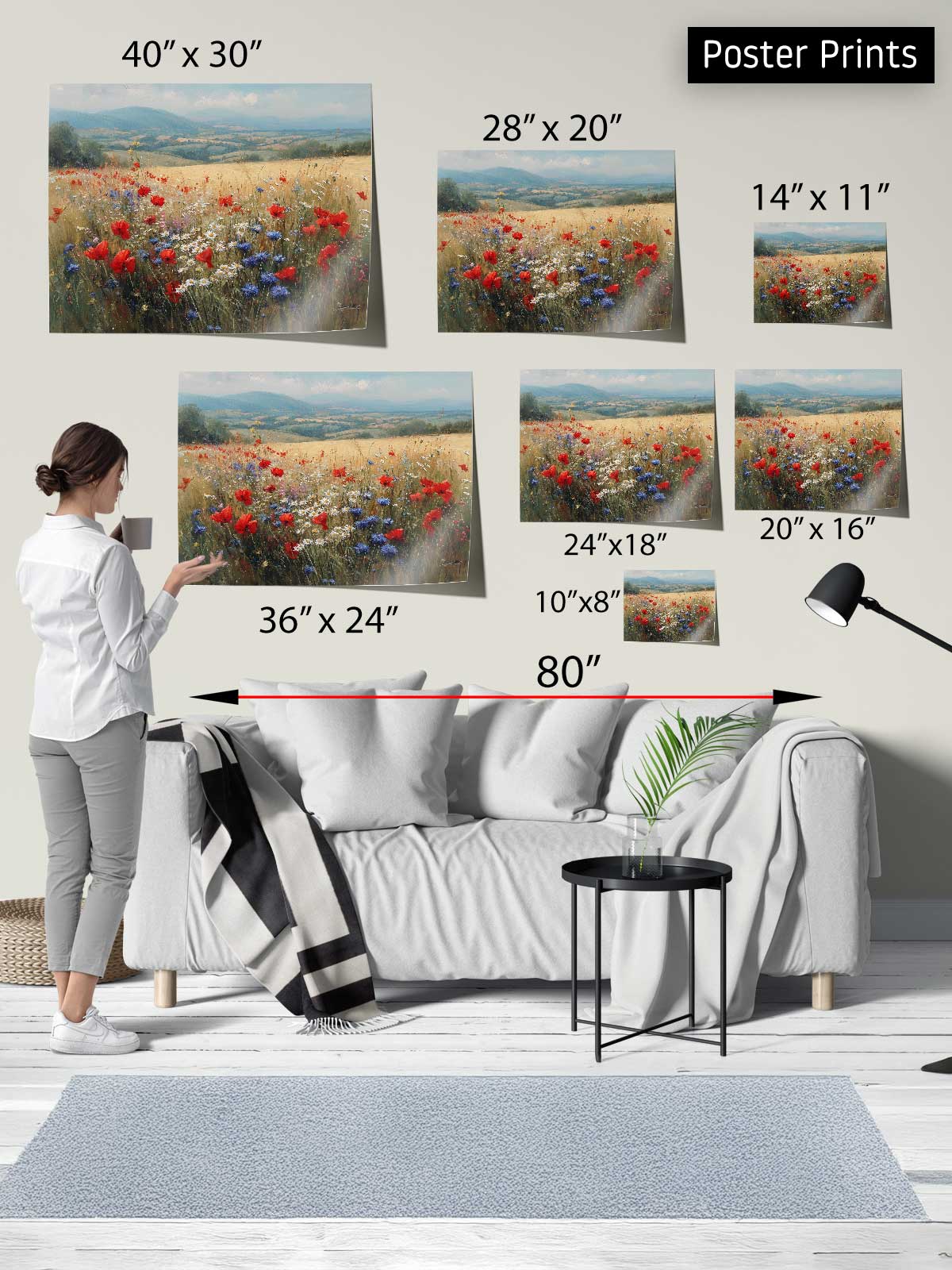 The image is a poster print display featuring a woman standing in front of a couch, with various sizes of the same floral print displayed on the wall behind her.