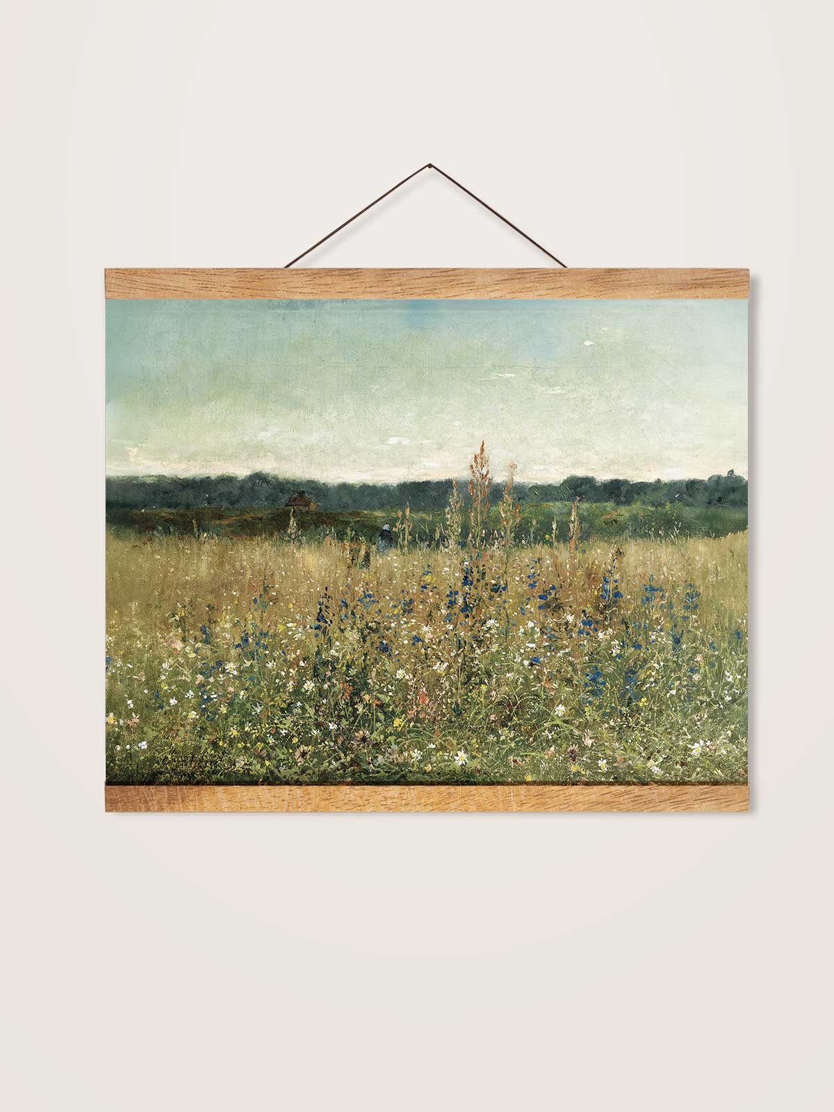 The image is a painting of a field with tall grass and wildflowers, hanging on a wall.
