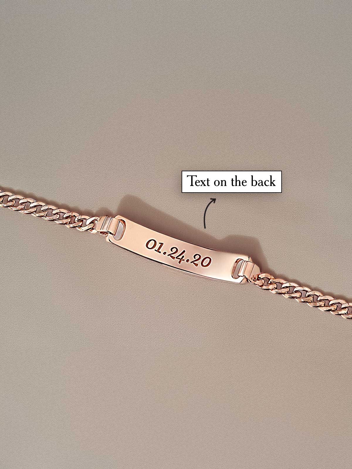 a gold bracelet with a name tag on it