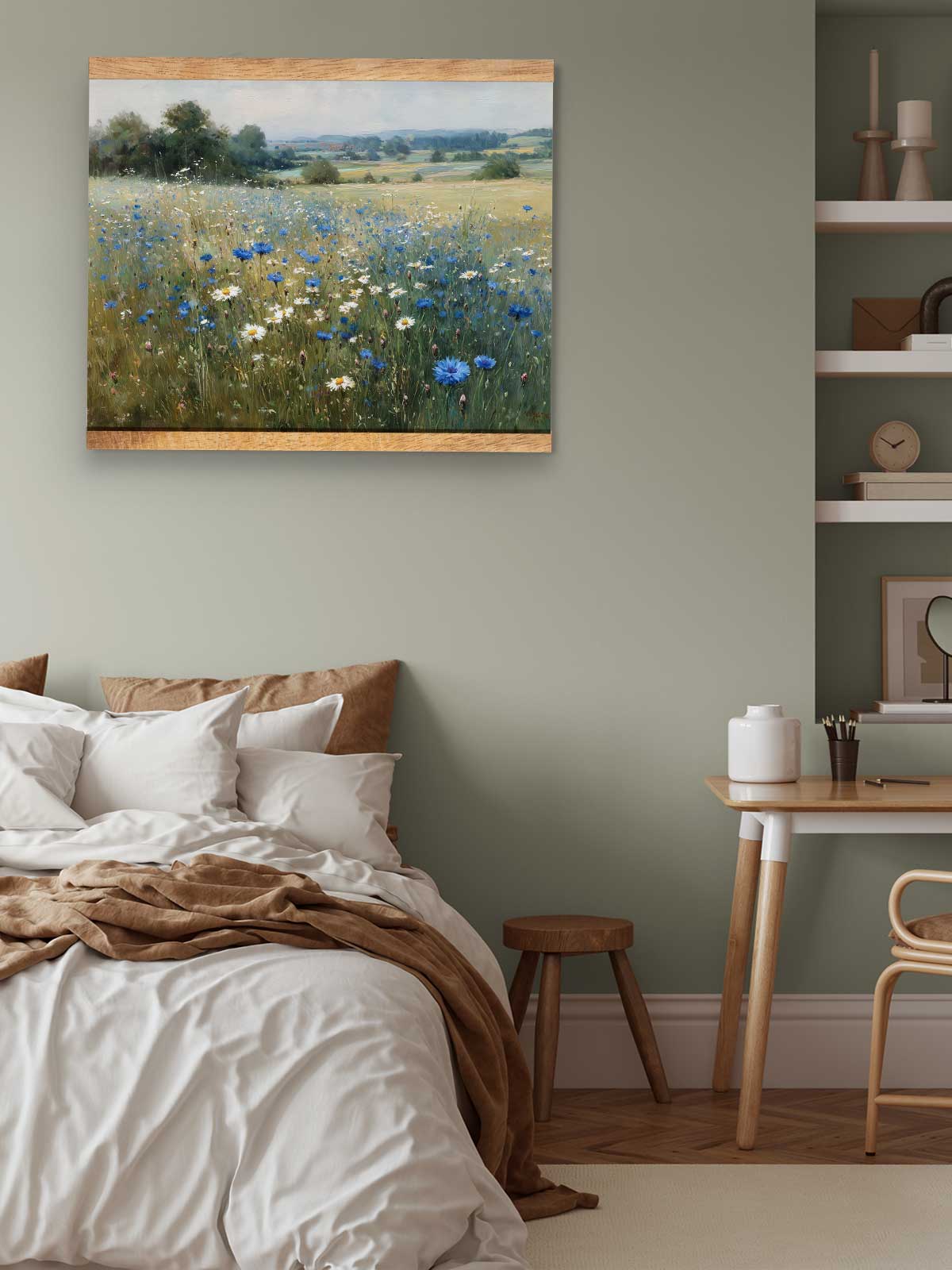 a serene bedroom scene with a bed, a wooden table, and a painting of a field of flowers hanging on the wall.