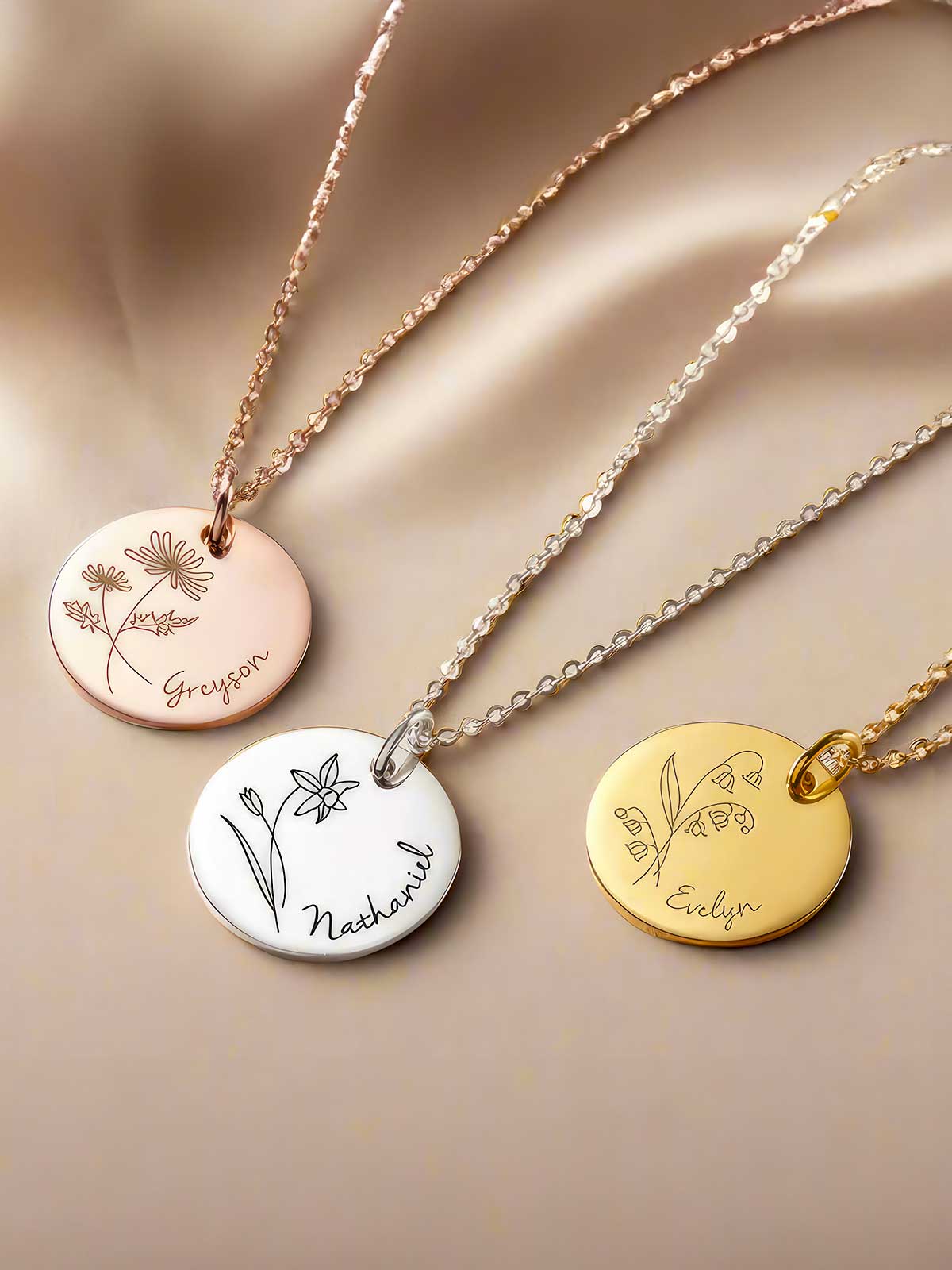 three different necklaces with flowers on them