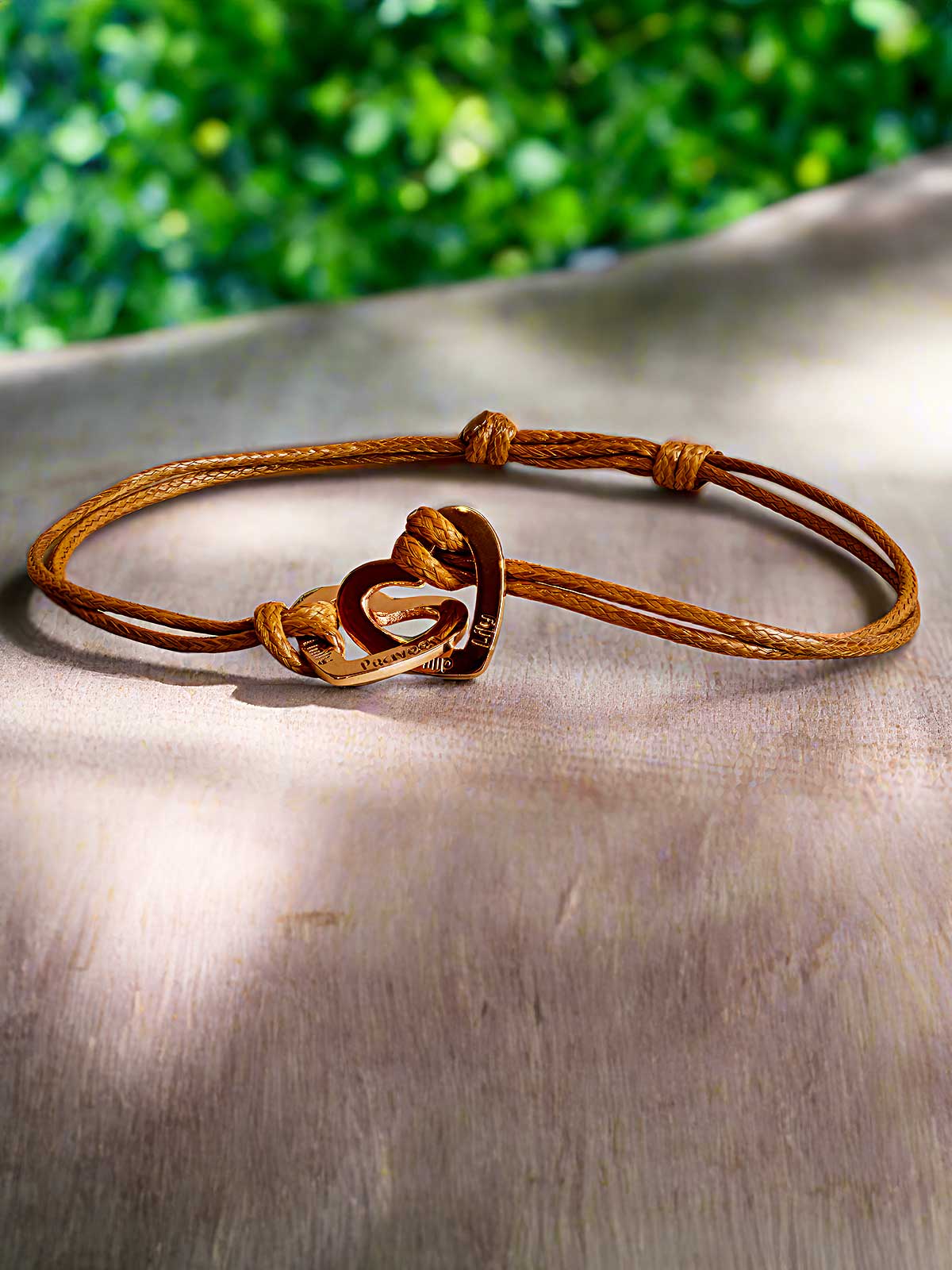 a brown leather bracelet with a knot on it