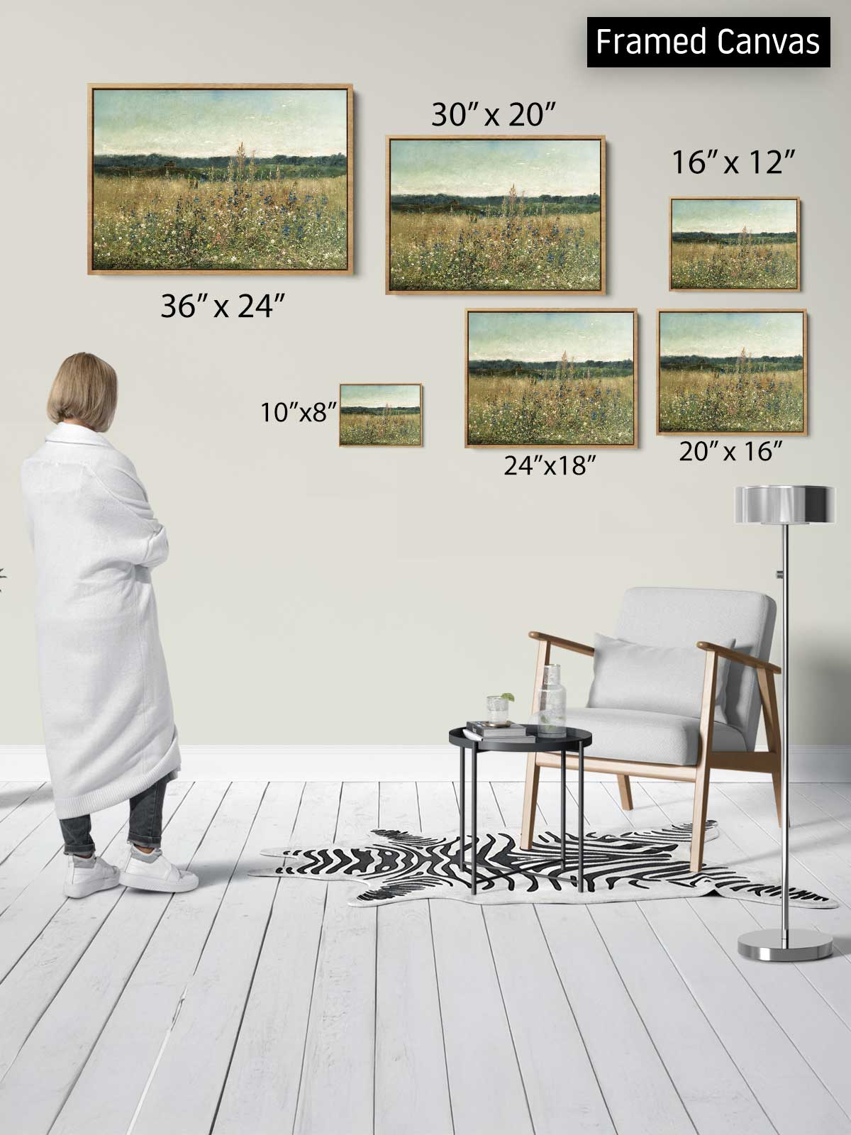 a person standing in a room, looking at a collection of framed paintings on the wall. The paintings vary in size and depict different scenes, including a field of flowers. The person appears to be examining the artwork, possibly appreciating the different perspectives and details presented in the paintings.